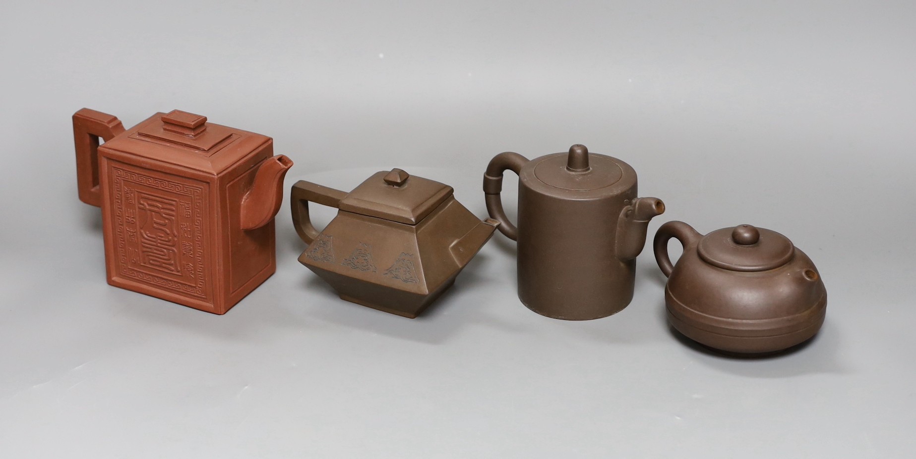 A Chinese Yixing rectangular teapot and three other Yixing teapots (4), Tallest 12 cms high